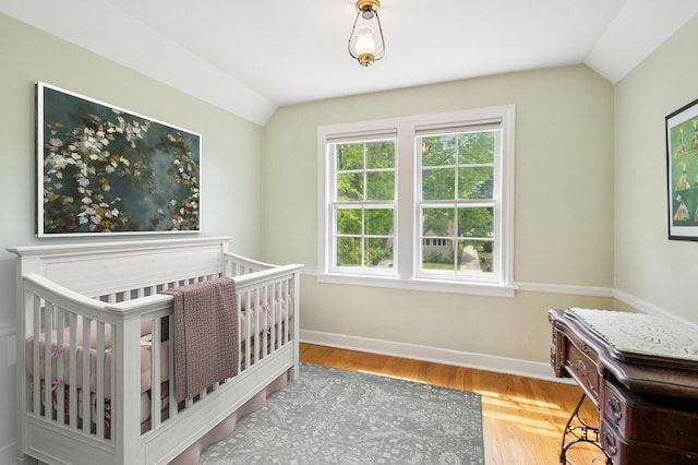 624 N Lombard Ave, Oak Park, IL 60302 - bedroom with lofted ceiling, wood finished floors, and a nursery area