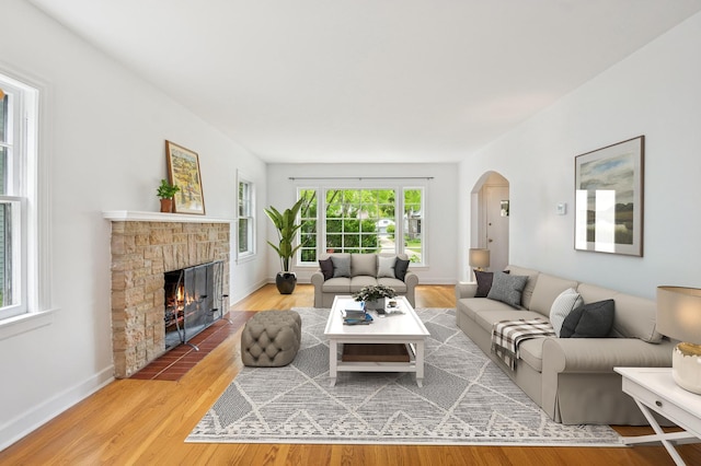 624 N Lombard Ave, Oak Park, IL 60302 - living area with arched walkways, a fireplace with flush hearth, and wood finished floors