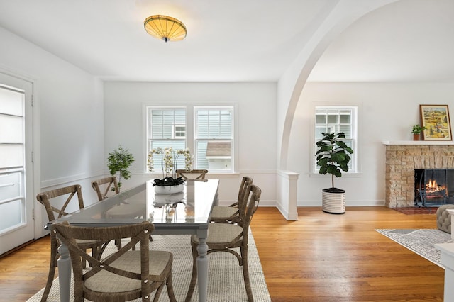 624 N Lombard Ave, Oak Park, IL 60302 - dining room featuring arched walkways, wood finished floors, and a stone fireplace