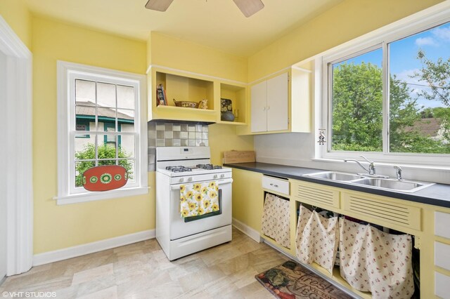 624 N Lombard Ave, Oak Park, IL 60302 - kitchen featuring white gas range oven, dark countertops, tasteful backsplash, open shelves, and a ceiling fan