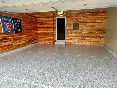 15910 W Ridge St, Lockport, IL 60441 - garage featuring wood walls, baseboards, and a garage door opener