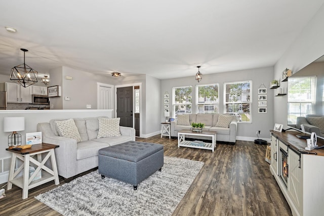 15910 W Ridge St, Lockport, IL 60441 - living room featuring a chandelier, dark wood finished floors, and baseboards