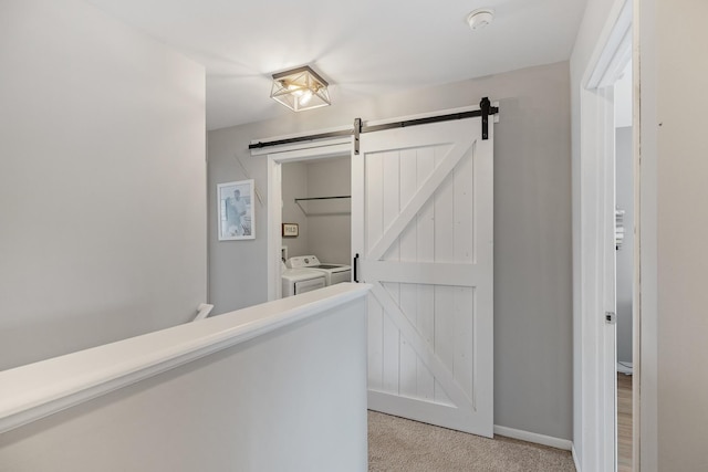 15910 W Ridge St, Lockport, IL 60441 - hallway featuring washing machine and clothes dryer, light carpet, a barn door, and baseboards