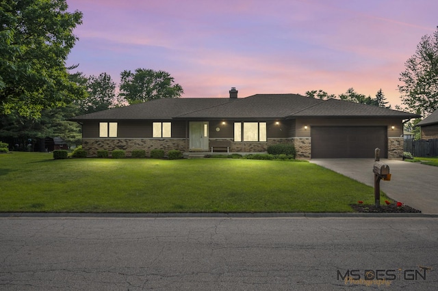 10 Primrose Ln, Sycamore, IL 60178 - view of front facade with driveway, a garage, a lawn, and a chimney