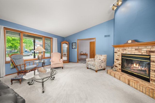 10 Primrose Ln, Sycamore, IL 60178 - carpeted living room featuring lofted ceiling, a fireplace, and baseboards