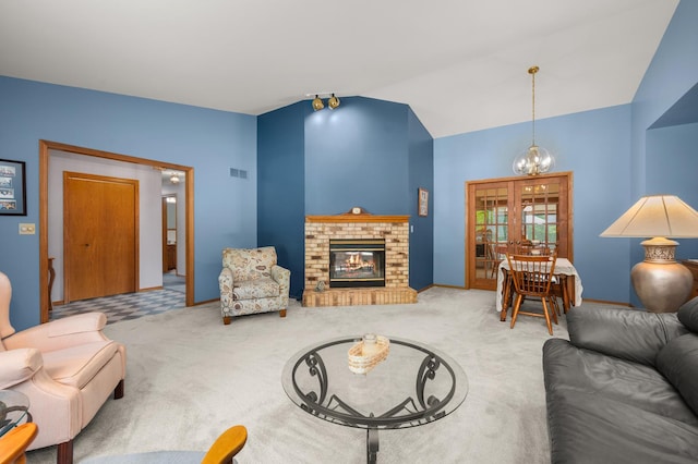 10 Primrose Ln, Sycamore, IL 60178 - living area featuring carpet floors, vaulted ceiling, a chandelier, and a brick fireplace