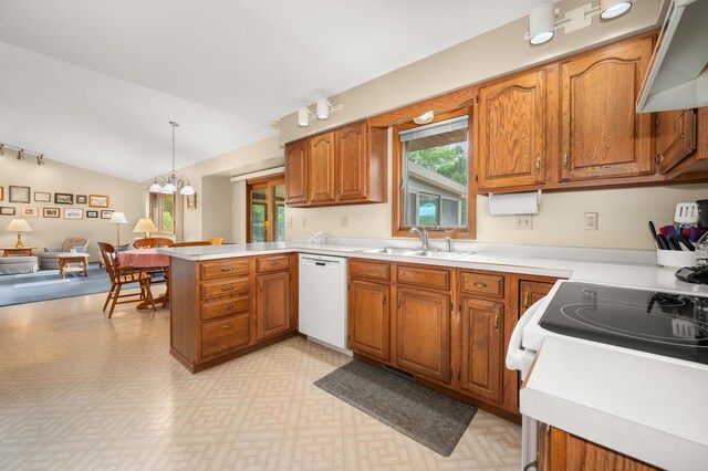 10 Primrose Ln, Sycamore, IL 60178 - kitchen featuring dishwasher, a sink, a peninsula, brown cabinetry, and lofted ceiling