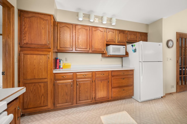 10 Primrose Ln, Sycamore, IL 60178 - kitchen featuring white appliances, brown cabinetry, and light countertops