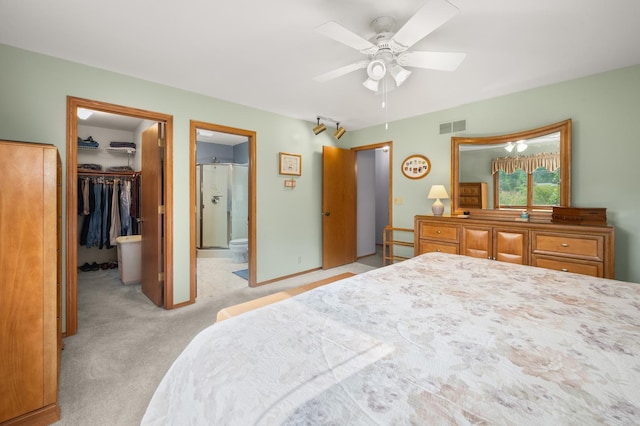 10 Primrose Ln, Sycamore, IL 60178 - bedroom with a walk in closet, light colored carpet, a closet, ensuite bathroom, and a ceiling fan