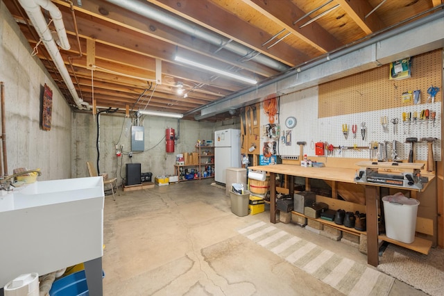 10 Primrose Ln, Sycamore, IL 60178 - unfinished basement with a workshop area, freestanding refrigerator, electric panel, a central vacuum unit, and a sink
