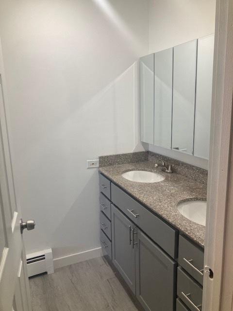129 Elk Trl W Unit 329, Carol Stream, IL 60188 - bathroom featuring a baseboard radiator, double vanity, and baseboards