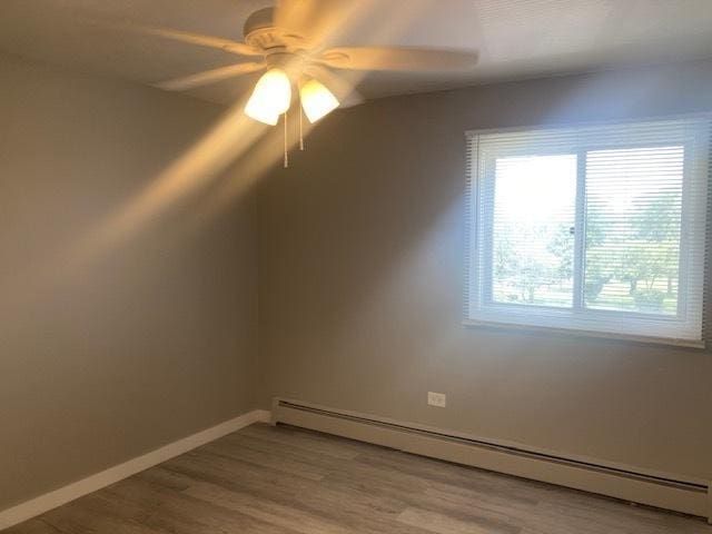 129 Elk Trl W Unit 329, Carol Stream, IL 60188 - unfurnished room featuring baseboard heating, ceiling fan, wood finished floors, and baseboards