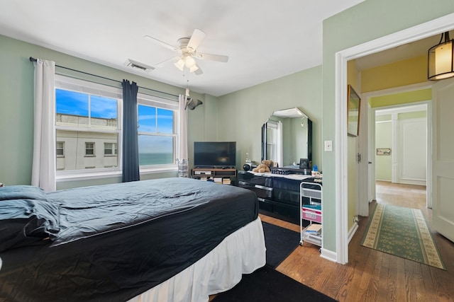 5555 N Sheridan Rd Unit 1906, Chicago, IL 60640 - bedroom with wood finished floors, arched walkways, and a ceiling fan