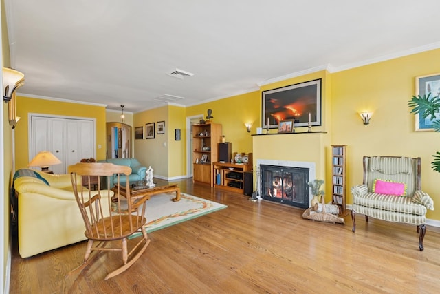 5555 N Sheridan Rd Unit 1906, Chicago, IL 60640 - living area featuring wood finished floors, baseboards, crown molding, and a glass covered fireplace