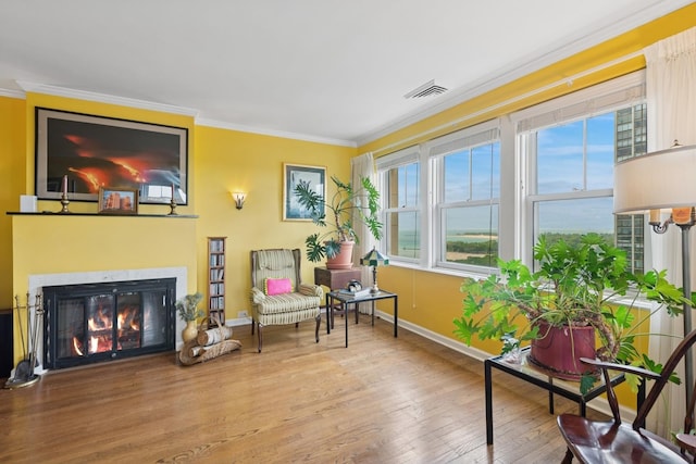 5555 N Sheridan Rd Unit 1906, Chicago, IL 60640 - sitting room with ornamental molding, wood finished floors, baseboards, healthy amount of natural light, and a glass covered fireplace