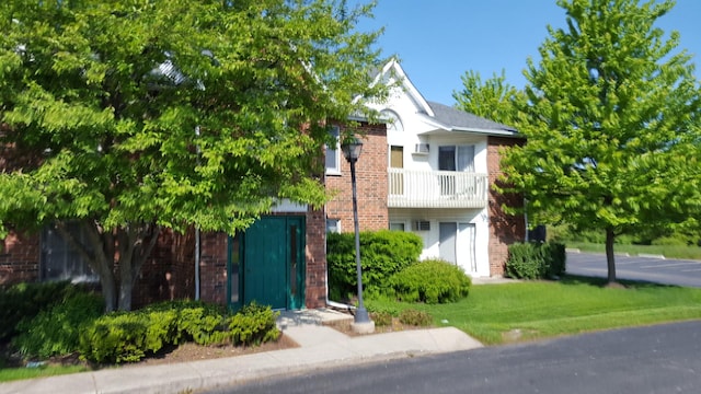 1341 Cunat Ct Unit 1C, Lake In The Hills, IL 60156 - view of front facade with brick siding and a balcony