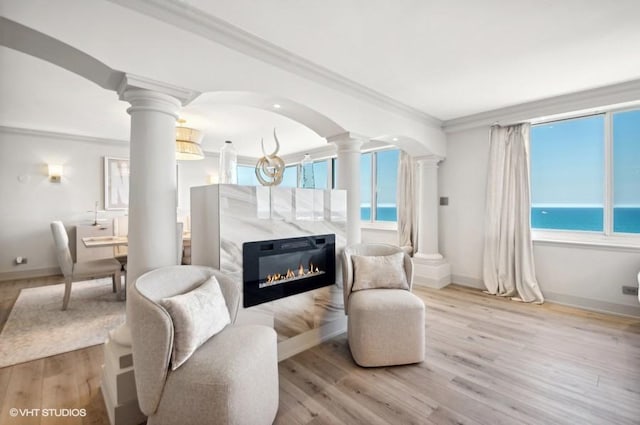 1440 N Lake Shore Dr Unit 34Ac, Chicago, IL 60610 - living room featuring decorative columns, crown molding, wood finished floors, baseboards, and a water view