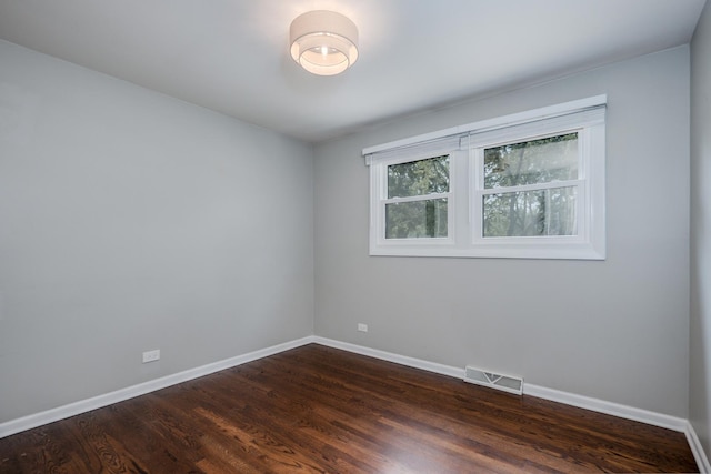 1110 71st St, Darien, IL 60561 - spare room with baseboards and dark wood finished floors