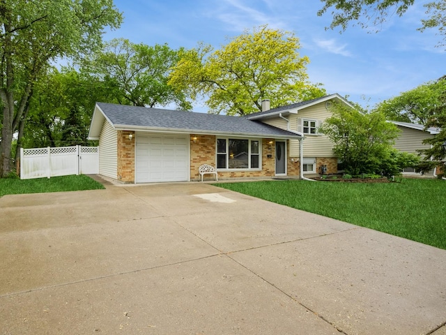 521 Harvard Ln, Hoffman Estates, IL 60169 - tri-level home with brick siding, an attached garage, driveway, and a shingled roof