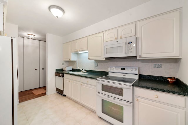 1615 E Central Rd Unit 410B, Arlington Heights, IL 60005 - kitchen featuring white appliances, a sink, dark countertops, and decorative backsplash
