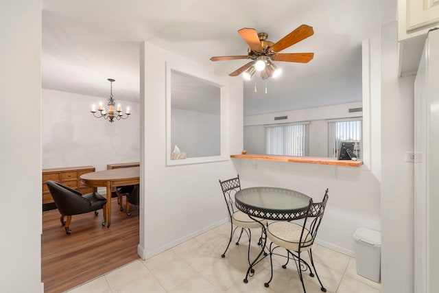 1615 E Central Rd Unit 410B, Arlington Heights, IL 60005 - dining area featuring ceiling fan, baseboards, and a chandelier