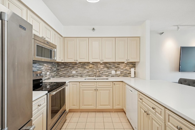 512 N Mcclurg Ct Unit 1009, Chicago, IL 60611 - kitchen featuring stainless steel appliances, a sink, cream cabinetry, and tasteful backsplash