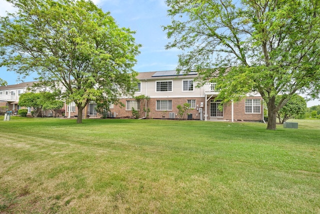 117 Andrew Taras Ct Unit B1, Joliet, IL 60435 - view of front facade with brick siding, a front lawn, roof mounted solar panels, and central air condition unit