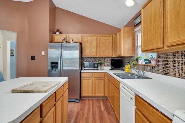 117 Andrew Taras Ct Unit B1, Joliet, IL 60435 - kitchen featuring appliances with stainless steel finishes, a sink, light countertops, light wood finished floors, and backsplash