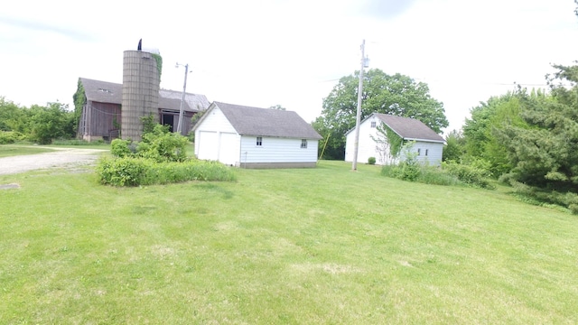 5250 Harvey Rd, Caledonia, IL 61011 - view of grassy yard featuring an outdoor structure and driveway