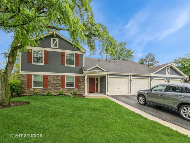 127 Wolcott Ct Unit 2, Schaumburg, IL 60193 - view of front of property featuring a garage, brick siding, asphalt driveway, and a front lawn