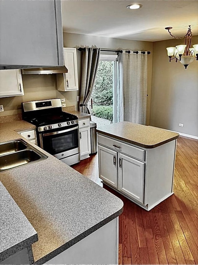 34165 N Goldenrod Rd, Round Lake, IL 60073 - kitchen featuring stainless steel stove, a center island, white cabinetry, a chandelier, and recessed lighting