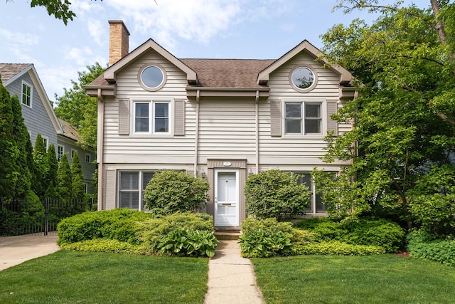 674 Foxdale Ave, Winnetka, IL 60093 - view of front of house featuring a front yard, a chimney, and roof with shingles