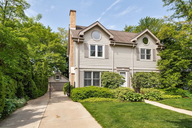674 Foxdale Ave, Winnetka, IL 60093 - view of front of home featuring a gate, a chimney, a front lawn, and a garage