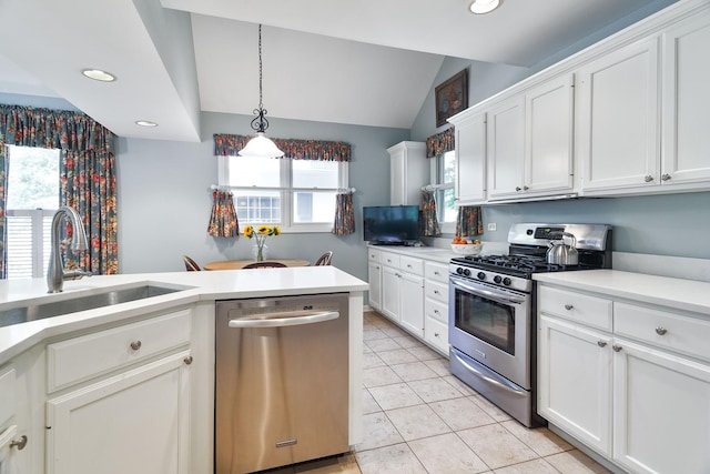 674 Foxdale Ave, Winnetka, IL 60093 - kitchen featuring appliances with stainless steel finishes, white cabinets, lofted ceiling, recessed lighting, and light countertops