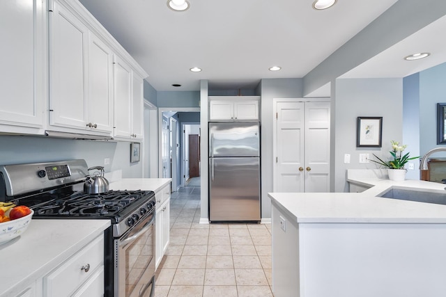 674 Foxdale Ave, Winnetka, IL 60093 - kitchen featuring appliances with stainless steel finishes, white cabinetry, light countertops, recessed lighting, and light tile patterned floors
