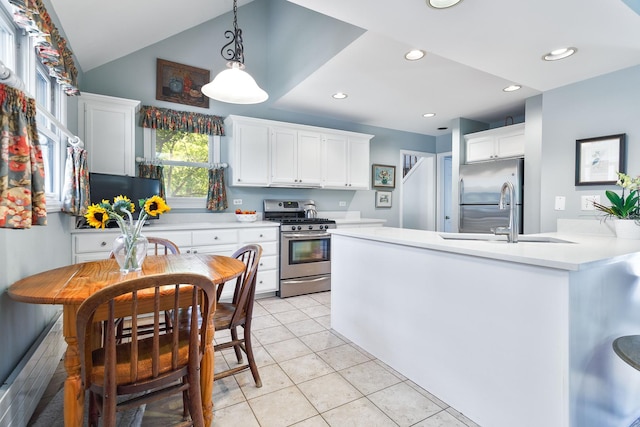 674 Foxdale Ave, Winnetka, IL 60093 - kitchen with stainless steel appliances, light countertops, white cabinets, vaulted ceiling, and recessed lighting
