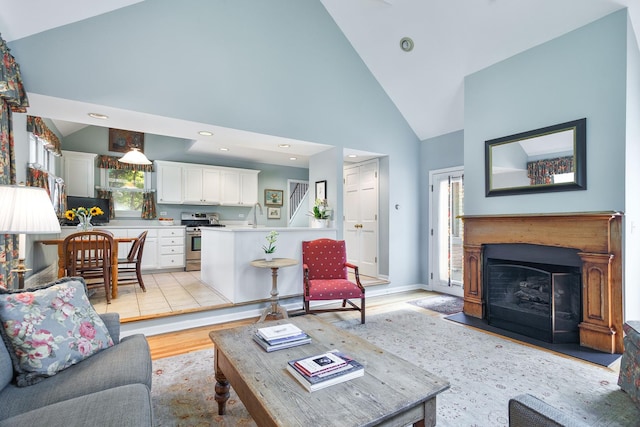 674 Foxdale Ave, Winnetka, IL 60093 - living area with high vaulted ceiling, light wood-style floors, and a fireplace with flush hearth