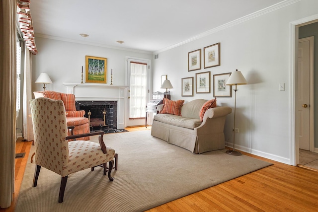 674 Foxdale Ave, Winnetka, IL 60093 - living area with a fireplace with flush hearth, ornamental molding, and wood finished floors