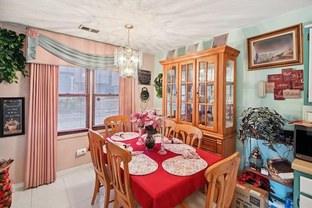 12755 S Kenneth Ave Unit E, Alsip, IL 60803 - dining room with a chandelier, a textured ceiling, light tile patterned flooring, and baseboards