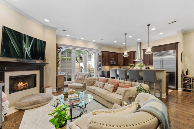 663 W Wellington Ave Unit 1, Chicago, IL 60657 - living room featuring wood finished floors, recessed lighting, a high end fireplace, crown molding, and baseboards