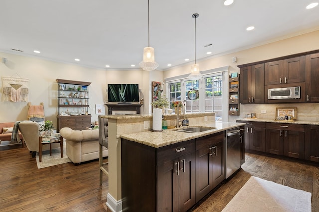 663 W Wellington Ave Unit 1, Chicago, IL 60657 - kitchen with a sink, appliances with stainless steel finishes, open floor plan, dark brown cabinetry, and recessed lighting