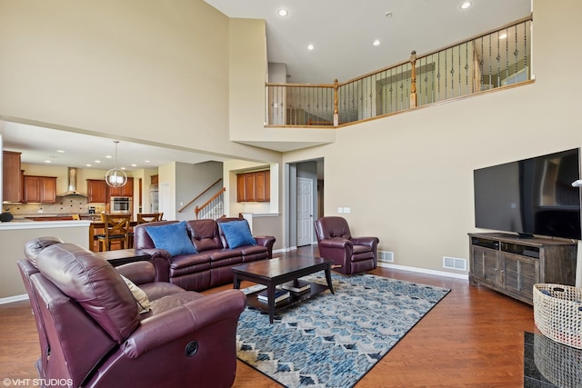 2621 Hastings Ct, Gurnee, IL 60031 - living room featuring stairway, wood finished floors, a high ceiling, baseboards, and recessed lighting