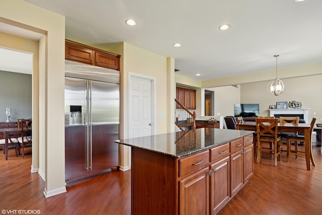 2621 Hastings Ct, Gurnee, IL 60031 - kitchen with built in refrigerator, dark wood-style floors, a center island, dark stone counters, and recessed lighting
