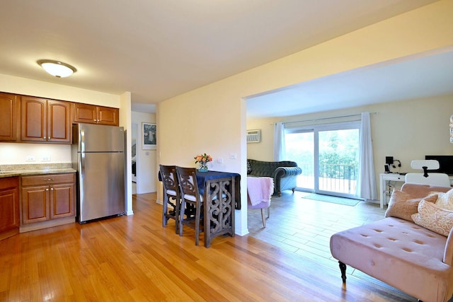 505 N Kenilworth Ave Unit 3, Glen Ellyn, IL 60137 - kitchen featuring freestanding refrigerator, light wood-style flooring, brown cabinetry, and open floor plan