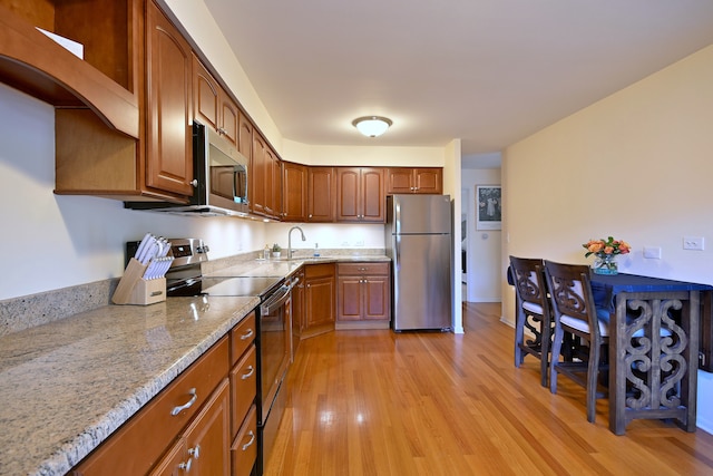 505 N Kenilworth Ave Unit 3, Glen Ellyn, IL 60137 - kitchen with stainless steel appliances, light stone counters, light wood finished floors, and a sink