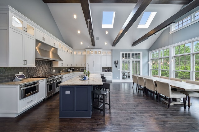 1308 N Wright St, Naperville, IL 60563 - kitchen with extractor fan, a skylight, an island with sink, range with two ovens, and beamed ceiling