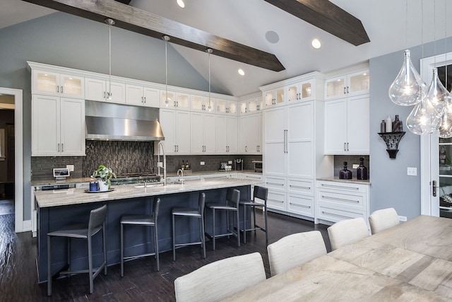1308 N Wright St, Naperville, IL 60563 - kitchen with under cabinet range hood, dark wood-style floors, tasteful backsplash, white cabinetry, and a kitchen bar