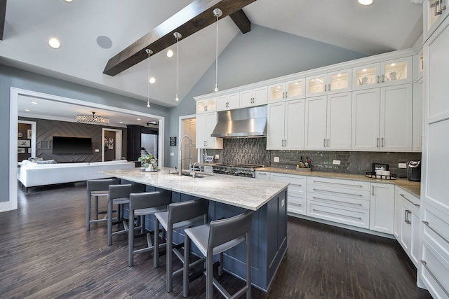 1308 N Wright St, Naperville, IL 60563 - kitchen with under cabinet range hood, beam ceiling, dark wood-style flooring, white cabinets, and glass insert cabinets