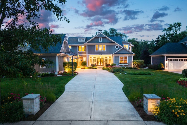 1308 N Wright St, Naperville, IL 60563 - view of front of home featuring a lawn, concrete driveway, board and batten siding, and a garage
