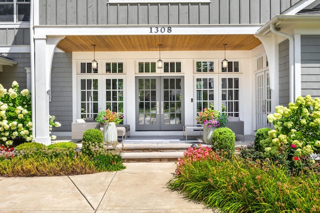 1308 N Wright St, Naperville, IL 60563 - doorway to property with french doors, covered porch, and board and batten siding